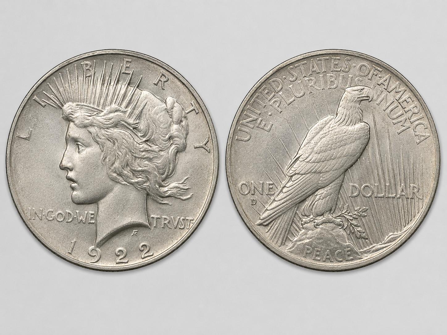 1922 Peace silver dollar obverse and reverse showing Liberty radiant-crown portrait and eagle perched on a rock with PEACE below.