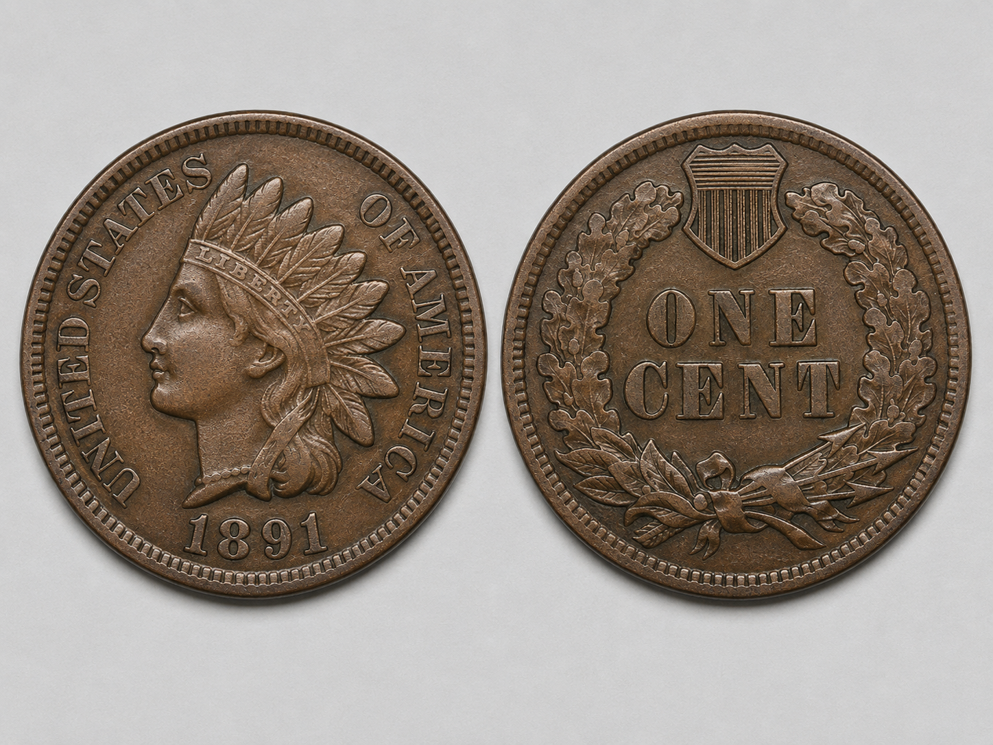 Indian Head cent obverse and reverse showing Liberty in feathered headdress, the date, and the oak wreath with shield reverse design.